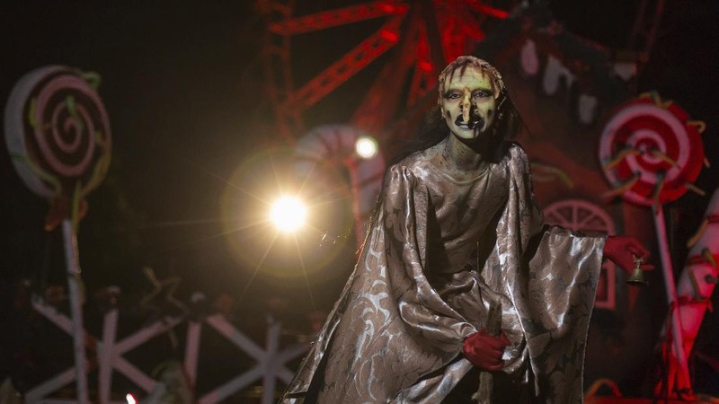 An actor dressed as a witch performs at the Hopi Hari horror theme amusement park, in the Vinhedo suburb of Sao Paulo, Brazil, Friday, Sept. 4, 2020. Due to the restrictions caused by COVID-19, the park created a drive-thru tour that allow the public to enjoy the experience by car. (AP Photo/Carla Carniel)