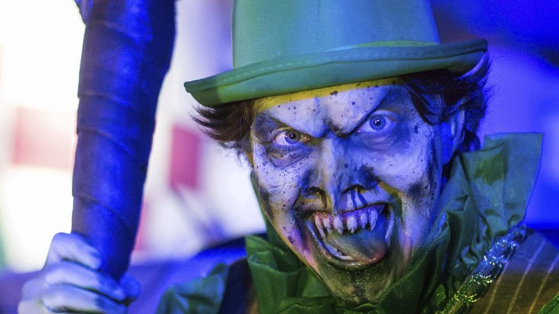 An actor dressed as a witch performs at the Hopi Hari horror theme amusement park, in the Vinhedo suburb of Sao Paulo, Brazil, Friday, Sept. 4, 2020. Due to the restrictions caused by COVID-19, the park created a drive-thru tour that allow the public to enjoy the experience by car. (AP Photo/Carla Carniel)