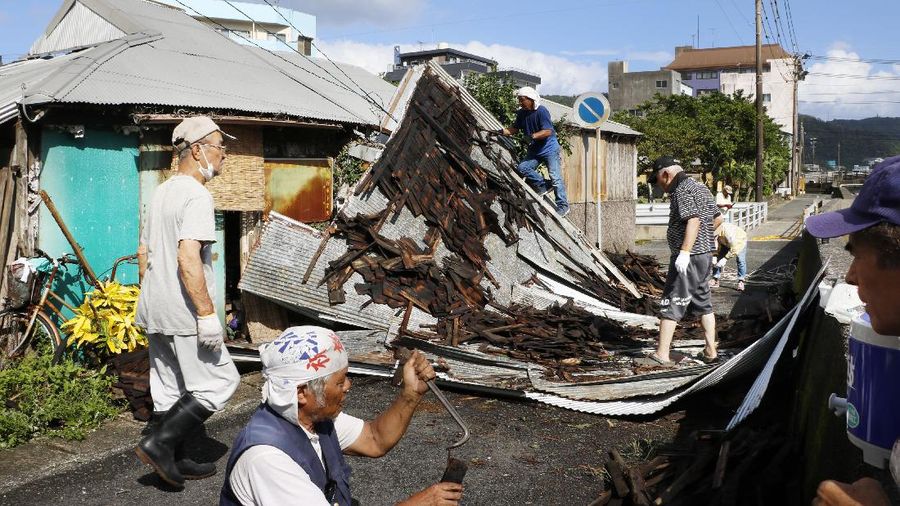 The roofs of a car factory are seen on sidewalk after typhoon hit Fukuoka, southwestern Japan Monday, Sept. 7, 2020. The second powerful typhoon to slam Japan in a week left people injured, damaged buildings, caused blackouts at nearly half a million homes and paralyzed traffic in southern Japanese islands before headed to South Korea.(Kyodo News via AP)
