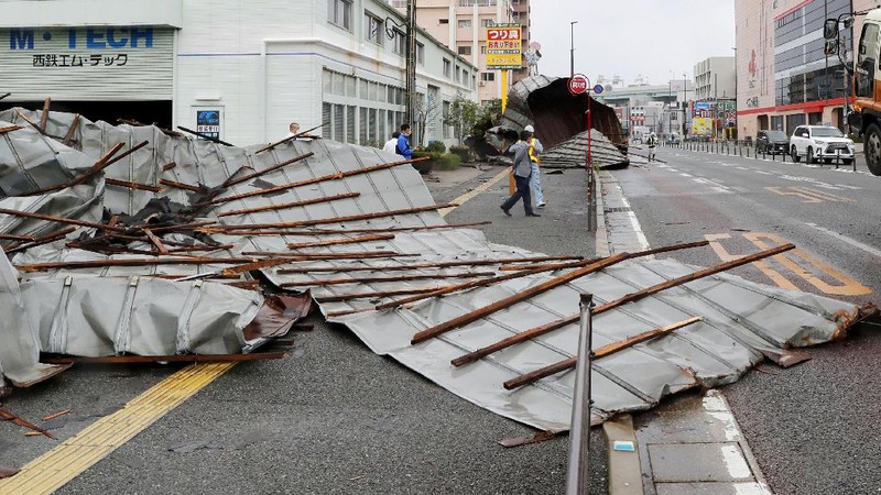 The roofs of a car factory are seen on sidewalk after typhoon hit Fukuoka, southwestern Japan Monday, Sept. 7, 2020. The second powerful typhoon to slam Japan in a week left people injured, damaged buildings, caused blackouts at nearly half a million homes and paralyzed traffic in southern Japanese islands before headed to South Korea.(Kyodo News via AP)