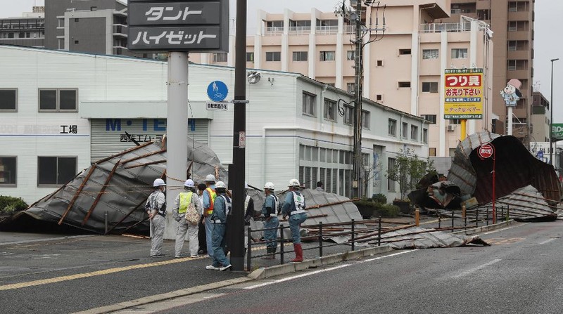 The roofs of a car factory are seen on sidewalk after typhoon hit Fukuoka, southwestern Japan Monday, Sept. 7, 2020. The second powerful typhoon to slam Japan in a week left people injured, damaged buildings, caused blackouts at nearly half a million homes and paralyzed traffic in southern Japanese islands before headed to South Korea.(Kyodo News via AP)