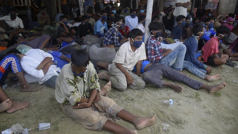 Ethnic Rohingya people rest after the boat carrying them landed in Lhokseumawe, Aceh province, Indonesia, early Monday, Sept. 7, 2020. Almost 300 Rohingya Muslims were found on a beach in Indonesia's Aceh province Monday and were evacuated by military, police and Red Cross volunteers, authorities said. (AP Photo/Rahmat Mirza)
