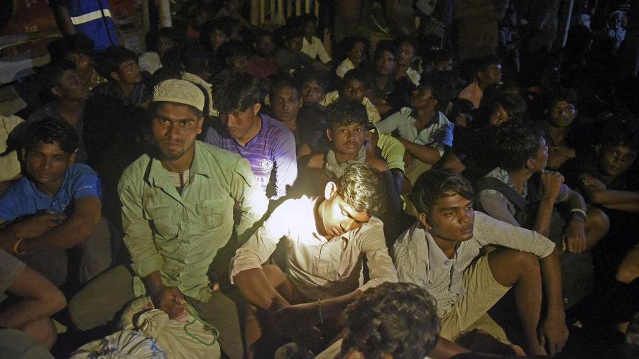 Ethnic Rohingya people rest after the boat carrying them landed in Lhokseumawe, Aceh province, Indonesia, early Monday, Sept. 7, 2020. Almost 300 Rohingya Muslims were found on a beach in Indonesia's Aceh province Monday and were evacuated by military, police and Red Cross volunteers, authorities said. (AP Photo/Rahmat Mirza)