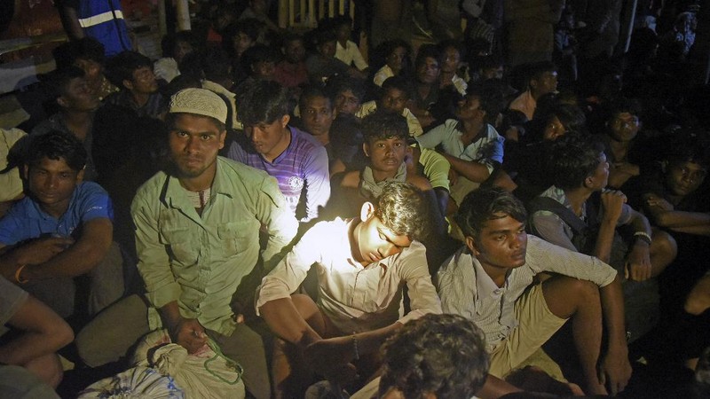 Ethnic Rohingya people rest after the boat carrying them landed in Lhokseumawe, Aceh province, Indonesia, early Monday, Sept. 7, 2020. Almost 300 Rohingya Muslims were found on a beach in Indonesia's Aceh province Monday and were evacuated by military, police and Red Cross volunteers, authorities said. (AP Photo/Rahmat Mirza)