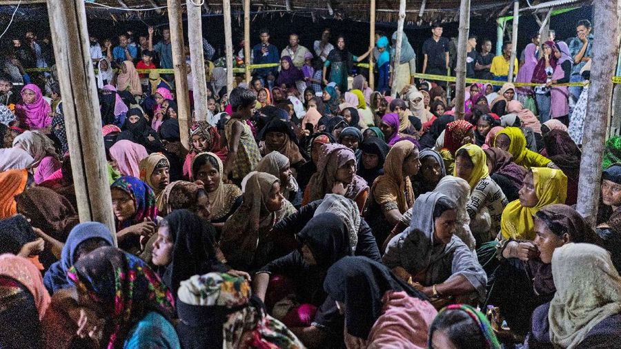 Ethnic Rohingya people rest after the boat carrying them landed in Lhokseumawe, Aceh province, Indonesia, early Monday, Sept. 7, 2020. Almost 300 Rohingya Muslims were found on a beach in Indonesia's Aceh province Monday and were evacuated by military, police and Red Cross volunteers, authorities said. (AP Photo/Zik Maulana)