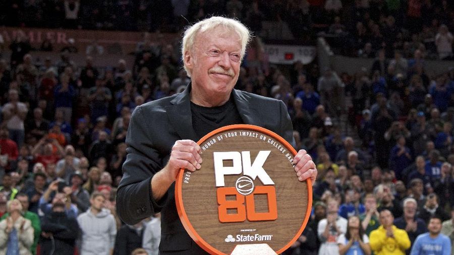 Nike co-founder Phil Knight is presented with a plaque during the first half of an NCAA college basketball game between Duke and Florida in the Phil Knight Invitational tournament in Portland, Ore., Sunday, Nov. 26, 2017. (AP Photo/Craig Mitchelldyer)