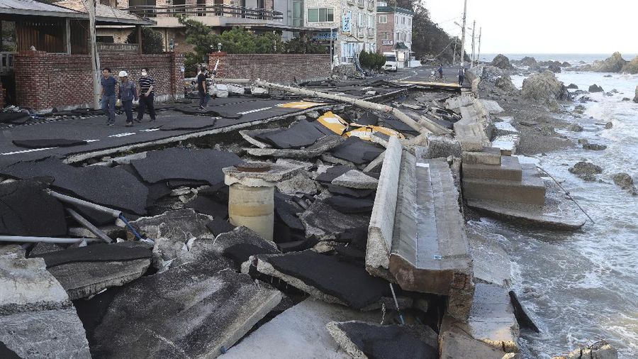 A coastal road is damaged by waves caused by Typhoon Haishen in Ulsan, South Korea, Monday, Sept. 7, 2020. A powerful typhoon damaged buildings, flooded roads and knocked out power to thousands of homes in South Korea on Monday after battering islands in southern Japan and injuring dozens of people. (Kim Yong-tai/Yonhap via AP)