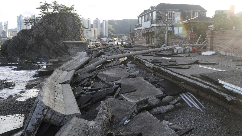 The roofs of a car factory are seen on sidewalk after typhoon hit Fukuoka, southwestern Japan Monday, Sept. 7, 2020. The second powerful typhoon to slam Japan in a week left people injured, damaged buildings, caused blackouts at nearly half a million homes and paralyzed traffic in southern Japanese islands before headed to South Korea.(Kyodo News via AP)