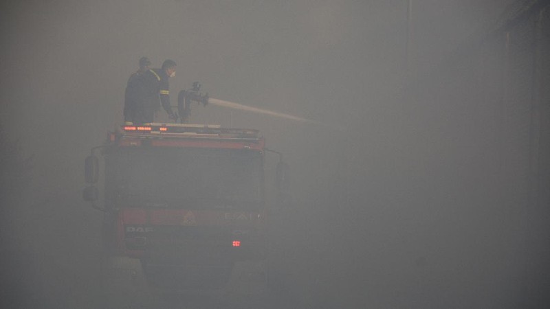 Firefighters try to extinguish a fire in the Moria refugee camp on the northeastern Aegean island of Lesbos, Greece, on Wednesday, Sept. 9, 2020. A fire swept through Greece's largest refugee camp that had been placed under COVID-19 lockdown, leaving more than 12,000 migrants in emergency need of shelter on the island of Lesbos. (AP Photo/Panagiotis Balaskas)