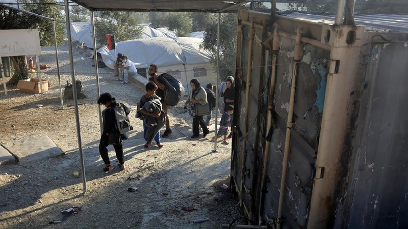 Firefighters try to extinguish a fire in the Moria refugee camp on the northeastern Aegean island of Lesbos, Greece, on Wednesday, Sept. 9, 2020. A fire swept through Greece's largest refugee camp that had been placed under COVID-19 lockdown, leaving more than 12,000 migrants in emergency need of shelter on the island of Lesbos. (AP Photo/Panagiotis Balaskas)