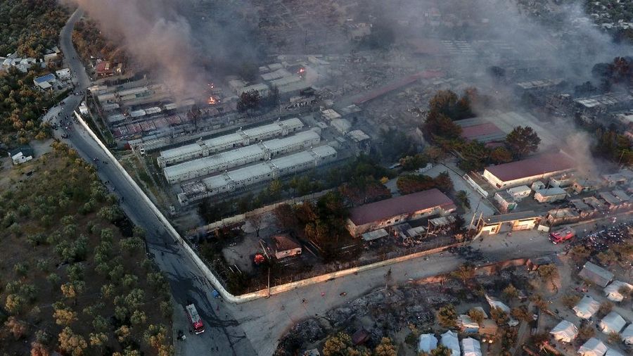 Firefighters try to extinguish a fire in the Moria refugee camp on the northeastern Aegean island of Lesbos, Greece, on Wednesday, Sept. 9, 2020. A fire swept through Greece's largest refugee camp that had been placed under COVID-19 lockdown, leaving more than 12,000 migrants in emergency need of shelter on the island of Lesbos. (AP Photo/Panagiotis Balaskas)