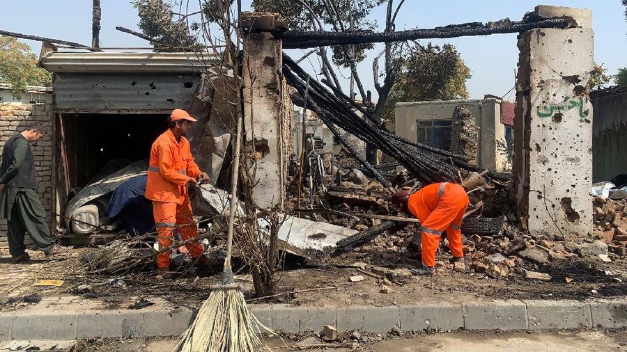 Afghan municipality workers clear debris at the site of an explosion in Kabul, Afghanistan, Wednesday, Sept. 9, 2020. Spokesman for Afghanistan's Interior Ministry said the bombing that targeted the convoy of the country's first vice president on Wednesday morning killed several people and wounded more than a dozen others, including several of the vice president's bodyguards. (AP Photo/Rahmat Gul)