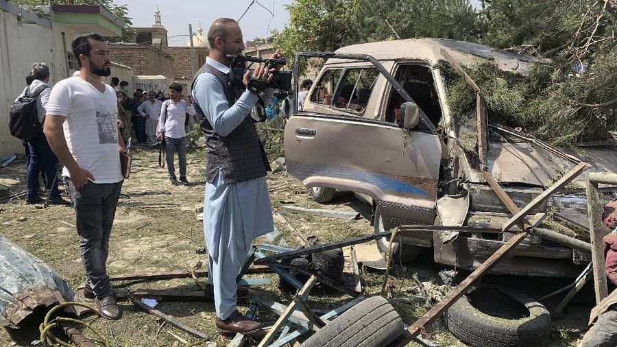 A cameraman scans the scene of an explosion in Kabul, Afghanistan, Wednesday, Sept. 9, 2020. A spokesman for Afghanistan's Interior Ministry said the bombing that targeted the convoy of the country's first vice president on Wednesday morning killed several people and wounded more than a dozen others, including several of the vice president's bodyguards. (AP Photo/Rahmat Gul)