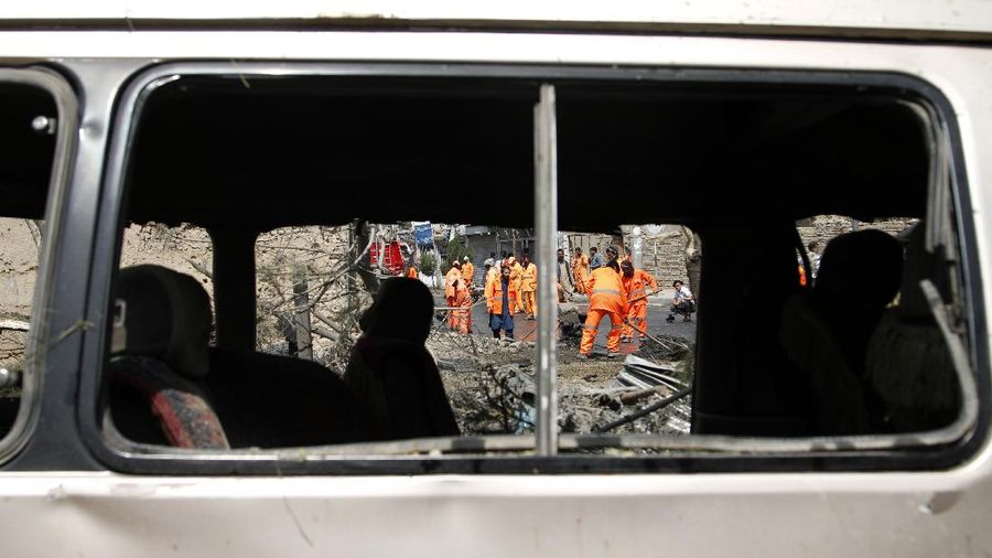 Afghan municipality workers clear debris at the site of an explosion in Kabul, Afghanistan, Wednesday, Sept. 9, 2020. Spokesman for Afghanistan's Interior Ministry said the bombing that targeted the convoy of the country's first vice president on Wednesday morning killed several people and wounded more than a dozen others, including several of the vice president's bodyguards. (AP Photo/Rahmat Gul)