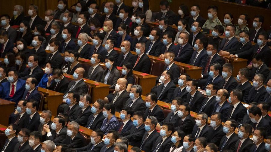 Attendees wearing face masks arrive for an event to honor some of those involved in China's fight against COVID-19 at the Great Hall of the People in Beijing, Tuesday, Sept. 8, 2020. Chinese leader Xi Jinping is praising China's role in battling the global coronavirus pandemic and expressing support for the U.N.'s World Health Organization, in a repudiation of U.S. criticism and a bid to rally domestic support for Communist Party leadership. (AP Photo/Mark Schiefelbein)