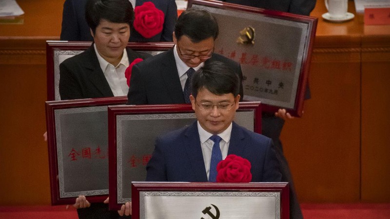 Attendees wearing face masks arrive for an event to honor some of those involved in China's fight against COVID-19 at the Great Hall of the People in Beijing, Tuesday, Sept. 8, 2020. Chinese leader Xi Jinping is praising China's role in battling the global coronavirus pandemic and expressing support for the U.N.'s World Health Organization, in a repudiation of U.S. criticism and a bid to rally domestic support for Communist Party leadership. (AP Photo/Mark Schiefelbein)