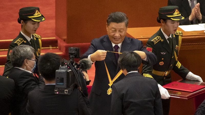 Attendees wearing face masks arrive for an event to honor some of those involved in China's fight against COVID-19 at the Great Hall of the People in Beijing, Tuesday, Sept. 8, 2020. Chinese leader Xi Jinping is praising China's role in battling the global coronavirus pandemic and expressing support for the U.N.'s World Health Organization, in a repudiation of U.S. criticism and a bid to rally domestic support for Communist Party leadership. (AP Photo/Mark Schiefelbein)