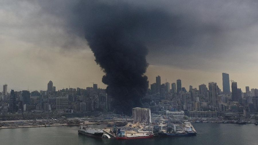 Firefighters work to extinguish a fire at warehouses at the seaport in Beirut, Lebanon, Thursday, Sept. 10. 2020. A huge fire broke out Thursday at the Port of Beirut, triggering panic among residents traumatized by last month's massive explosion that killed and injured thousands of people. (AP Photo/Hassan Ammar)