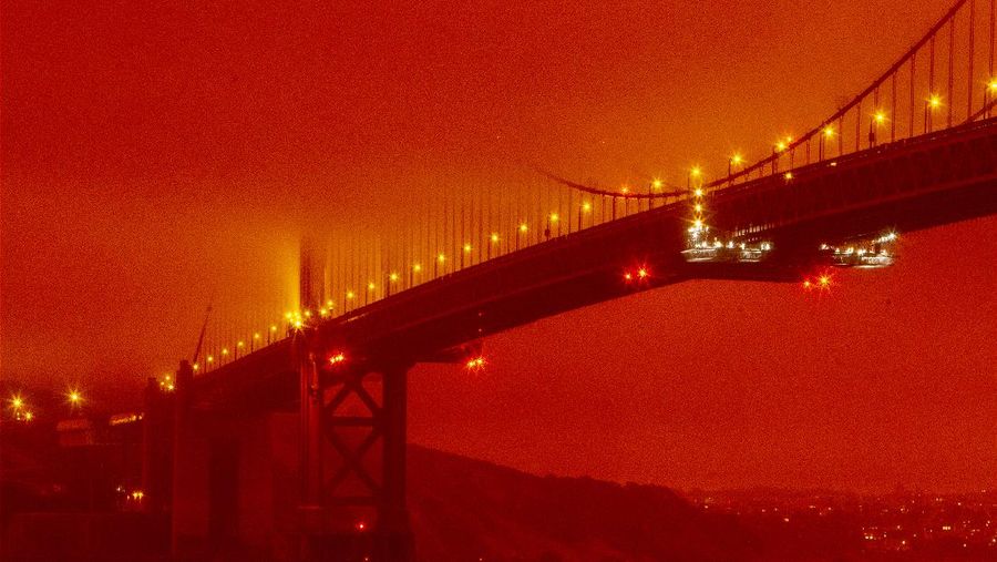 A firefighter battles the Creek Fire as it threatens homes in the Cascadel Woods neighborhood of Madera County, Calif., on Monday, Sept. 7, 2020. (AP Photo/Noah Berger)