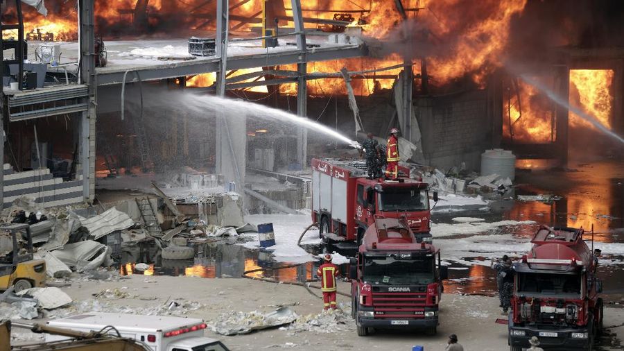 Firefighters work to extinguish a fire at warehouses at the seaport in Beirut, Lebanon, Thursday, Sept. 10. 2020. A huge fire broke out Thursday at the Port of Beirut, triggering panic among residents traumatized by last month's massive explosion that killed and injured thousands of people. (AP Photo/Hassan Ammar)