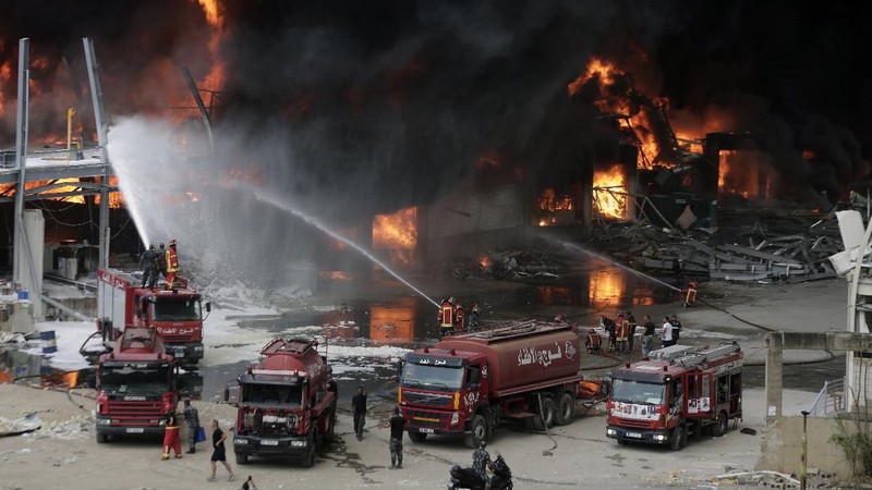 Firefighters work to extinguish a fire at warehouses at the seaport in Beirut, Lebanon, Thursday, Sept. 10. 2020. A huge fire broke out Thursday at the Port of Beirut, triggering panic among residents traumatized by last month's massive explosion that killed and injured thousands of people. (AP Photo/Hassan Ammar)