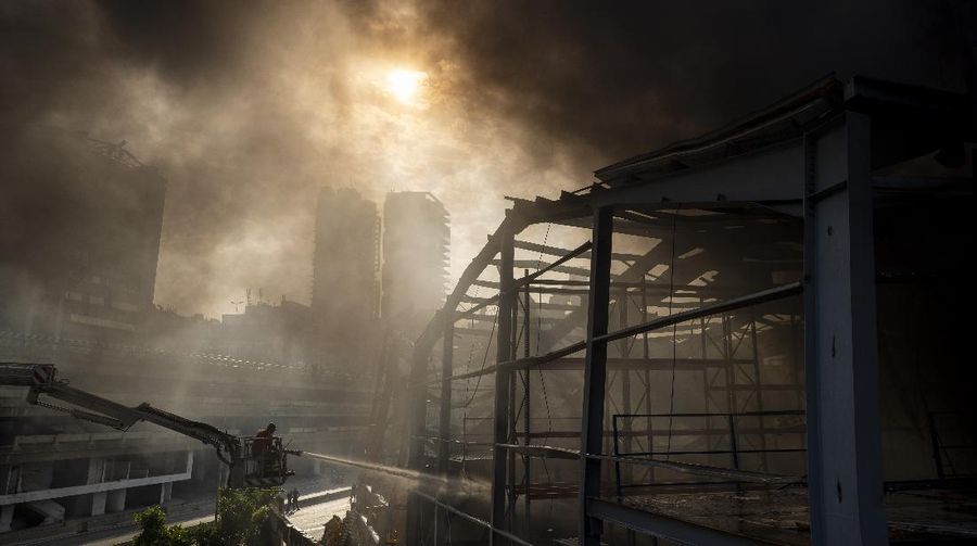 Firefighters work to extinguish a fire at warehouses at the seaport in Beirut, Lebanon, Thursday, Sept. 10. 2020. A huge fire broke out Thursday at the Port of Beirut, triggering panic among residents traumatized by last month's massive explosion that killed and injured thousands of people. (AP Photo/Hassan Ammar)