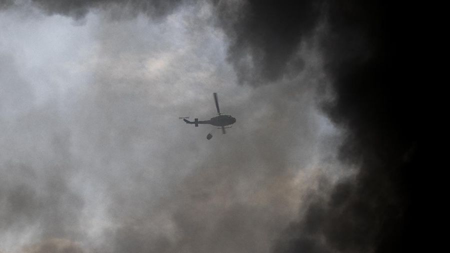 Firefighters work to extinguish a fire at warehouses at the seaport in Beirut, Lebanon, Thursday, Sept. 10. 2020. A huge fire broke out Thursday at the Port of Beirut, triggering panic among residents traumatized by last month's massive explosion that killed and injured thousands of people. (AP Photo/Hassan Ammar)