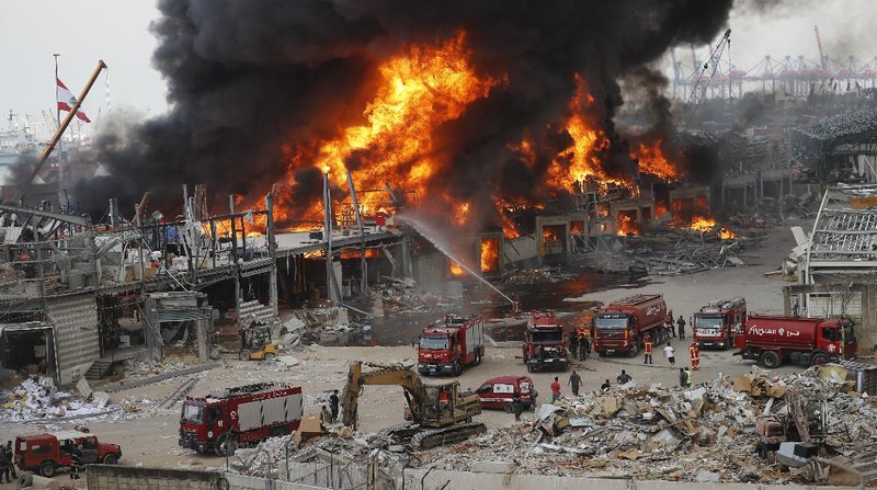 Firefighters work to extinguish a fire at warehouses at the seaport in Beirut, Lebanon, Thursday, Sept. 10. 2020. A huge fire broke out Thursday at the Port of Beirut, triggering panic among residents traumatized by last month's massive explosion that killed and injured thousands of people. (AP Photo/Hassan Ammar)
