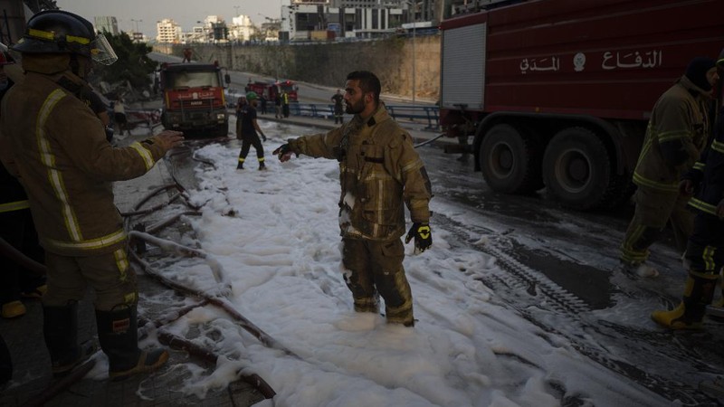 Firefighters work to extinguish a fire at warehouses at the seaport in Beirut, Lebanon, Thursday, Sept. 10. 2020. A huge fire broke out Thursday at the Port of Beirut, triggering panic among residents traumatized by last month's massive explosion that killed and injured thousands of people. (AP Photo/Hassan Ammar)