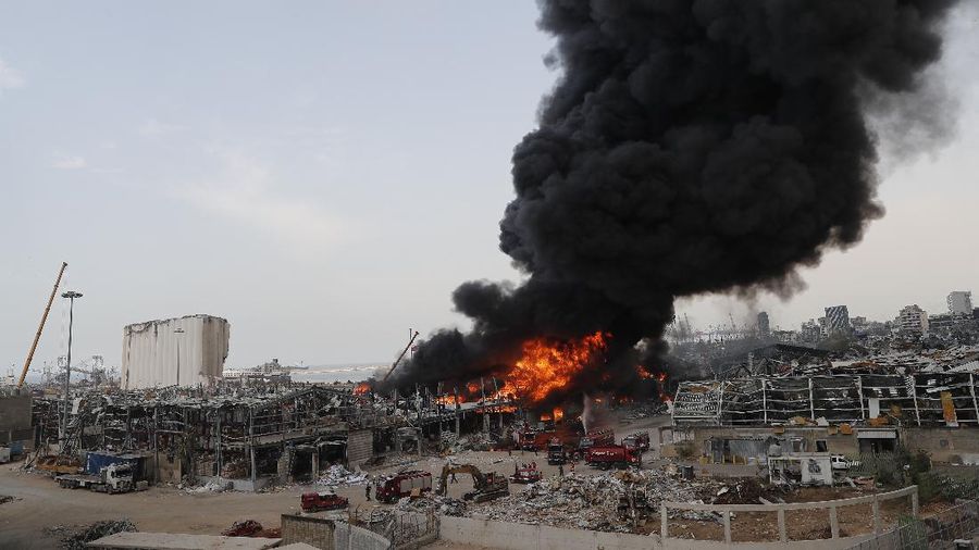 Firefighters work to extinguish a fire at warehouses at the seaport in Beirut, Lebanon, Thursday, Sept. 10. 2020. A huge fire broke out Thursday at the Port of Beirut, triggering panic among residents traumatized by last month's massive explosion that killed and injured thousands of people. (AP Photo/Hassan Ammar)
