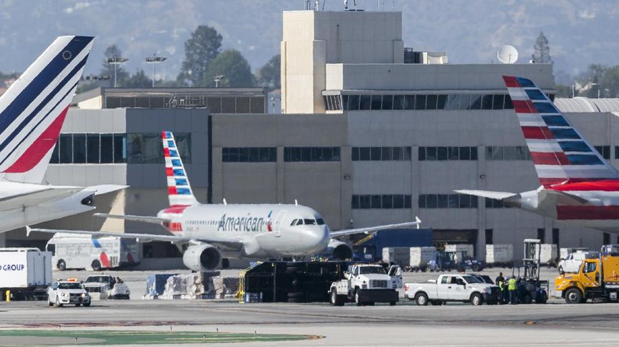 Two LAN jet liners sit parked on the tarmac at the airport in Santiago, Chile, Monday, July 25, 2016. LATAM airlines created in 2012 after a fusion between the airlines LAN of Chile and TAM of Brazil, has agreed to pay more than $22 million in fines related with a scheme to bribe Argentine union officials via a false consulting contract. The airline will pay the fine to the Securities and Exchange Commission (SEC) and the Department of Justice (DOJ) for a violation of the accounting provisions of the Foreign Corrupt Practices Act. (AP Photo/Esteban Felix)