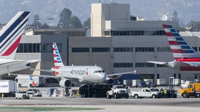 Two LAN jet liners sit parked on the tarmac at the airport in Santiago, Chile, Monday, July 25, 2016. LATAM airlines created in 2012 after a fusion between the airlines LAN of Chile and TAM of Brazil, has agreed to pay more than $22 million in fines related with a scheme to bribe Argentine union officials via a false consulting contract. The airline will pay the fine to the Securities and Exchange Commission (SEC) and the Department of Justice (DOJ) for a violation of the accounting provisions of the Foreign Corrupt Practices Act. (AP Photo/Esteban Felix)