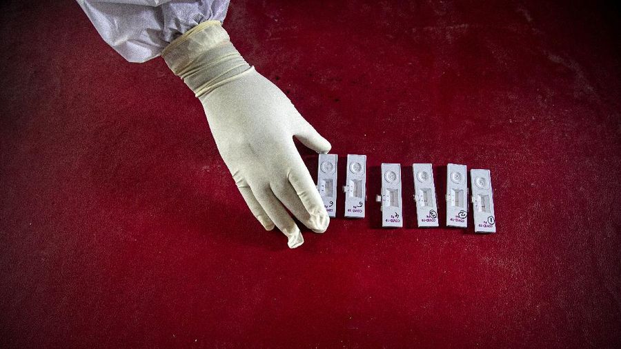 An Indian health worker takes nasal swab samples to test for COVID-19 in Gauhati, India, Sunday, Sept. 6, 2020. India's coronavirus cases have crossed 4 million, leading the world in new infections and deepening misery in the country's vast hinterlands where surges have crippled the underfunded health care system. (AP Photo/Anupam Nath)