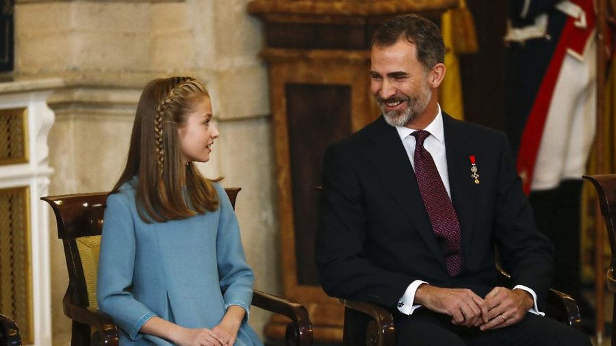 Spain's King Felipe sits next to his daughter Princess Leonor during a ceremony in which Princess Leonor was presented with the insignia of the