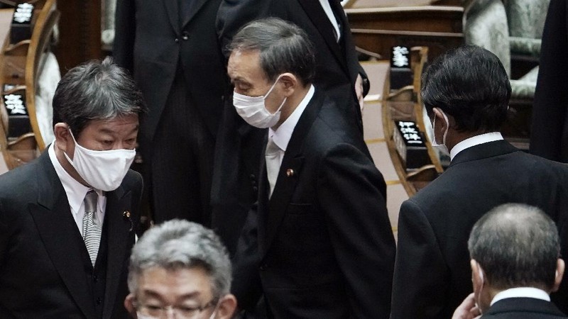 Japan's new Prime Minister Yoshihide Suga, center, walks out after attending an extraordinary session at the upper house of parliament Thursday, Sept. 17, 2020, in Tokyo. Suga started his first full day in office Thursday, with a resolve to push for reforms for the people, and he said he is already taking a crack at it. (AP Photo/Eugene Hoshiko)
