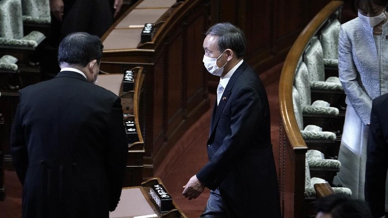 Japan's new Prime Minister Yoshihide Suga, center, walks out after attending an extraordinary session at the upper house of parliament Thursday, Sept. 17, 2020, in Tokyo. Suga started his first full day in office Thursday, with a resolve to push for reforms for the people, and he said he is already taking a crack at it. (AP Photo/Eugene Hoshiko)