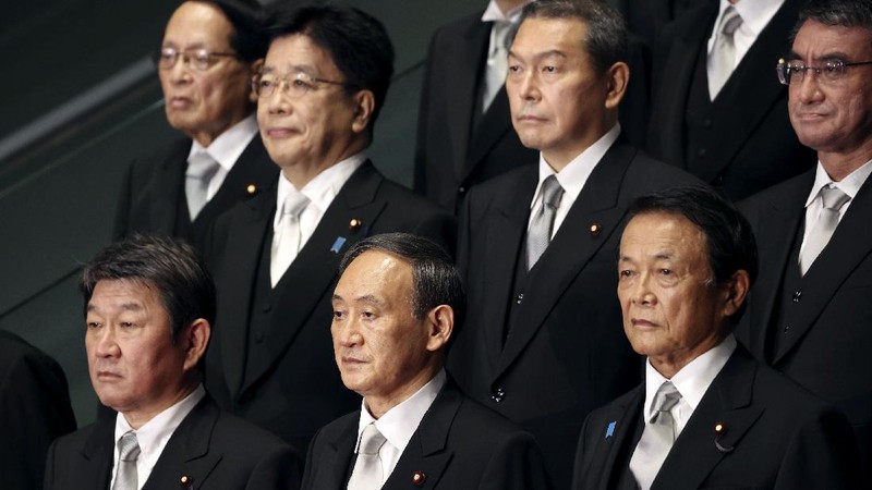 Japan's new Prime Minister Yoshihide Suga, center, walks out after attending an extraordinary session at the upper house of parliament Thursday, Sept. 17, 2020, in Tokyo. Suga started his first full day in office Thursday, with a resolve to push for reforms for the people, and he said he is already taking a crack at it. (AP Photo/Eugene Hoshiko)