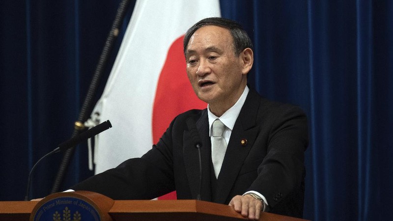 Japan's new Prime Minister Yoshihide Suga, center, walks out after attending an extraordinary session at the upper house of parliament Thursday, Sept. 17, 2020, in Tokyo. Suga started his first full day in office Thursday, with a resolve to push for reforms for the people, and he said he is already taking a crack at it. (AP Photo/Eugene Hoshiko)