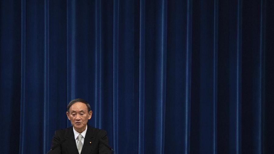 Japan's new Prime Minister Yoshihide Suga, center, walks out after attending an extraordinary session at the upper house of parliament Thursday, Sept. 17, 2020, in Tokyo. Suga started his first full day in office Thursday, with a resolve to push for reforms for the people, and he said he is already taking a crack at it. (AP Photo/Eugene Hoshiko)