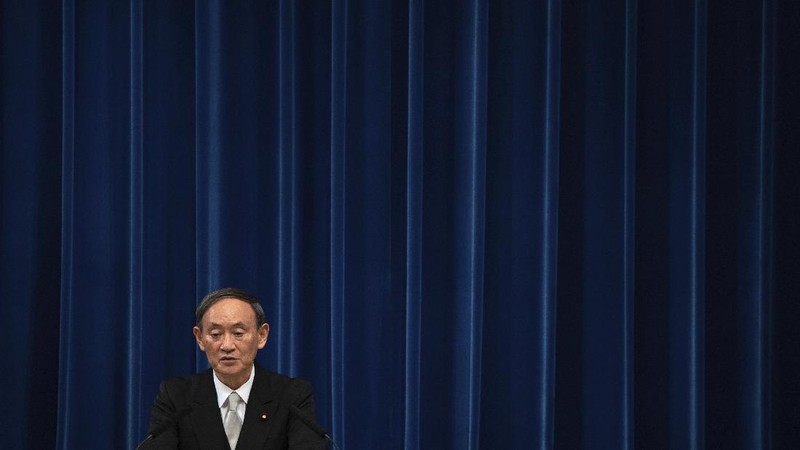 Japan's new Prime Minister Yoshihide Suga, center, walks out after attending an extraordinary session at the upper house of parliament Thursday, Sept. 17, 2020, in Tokyo. Suga started his first full day in office Thursday, with a resolve to push for reforms for the people, and he said he is already taking a crack at it. (AP Photo/Eugene Hoshiko)