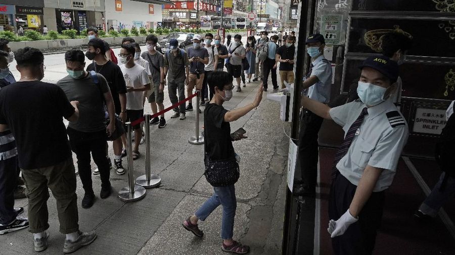 Gaming enthusiasts queue up for the pre-order sales of the newly unveiled Japanese brand video game console, Sony's PlayStation 5 (PS5), outside a retailer in Hong Kong, Friday, Sept. 18, 2020. Pre-orders of PlayStation 5 started on Sept. 17 and will be filled on Nov. 19. (AP Photo/Kin Cheung)