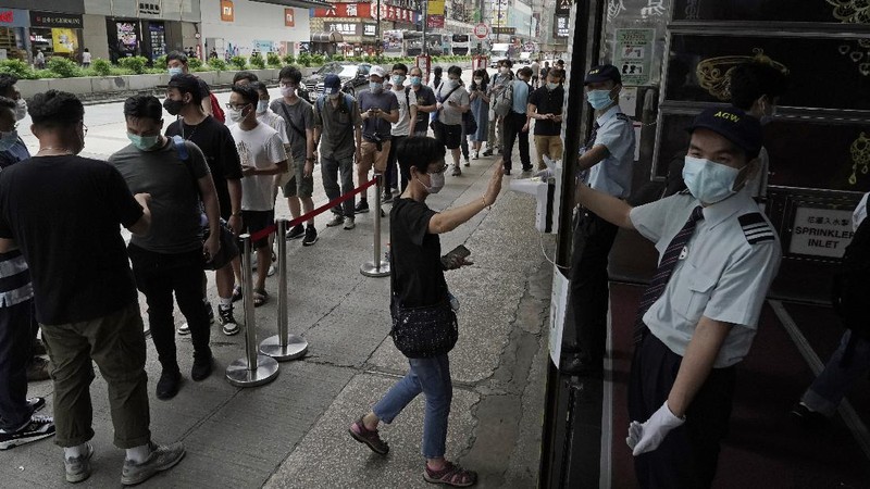 Gaming enthusiasts queue up for the pre-order sales of the newly unveiled Japanese brand video game console, Sony's PlayStation 5 (PS5), outside a retailer in Hong Kong, Friday, Sept. 18, 2020. Pre-orders of PlayStation 5 started on Sept. 17 and will be filled on Nov. 19. (AP Photo/Kin Cheung)