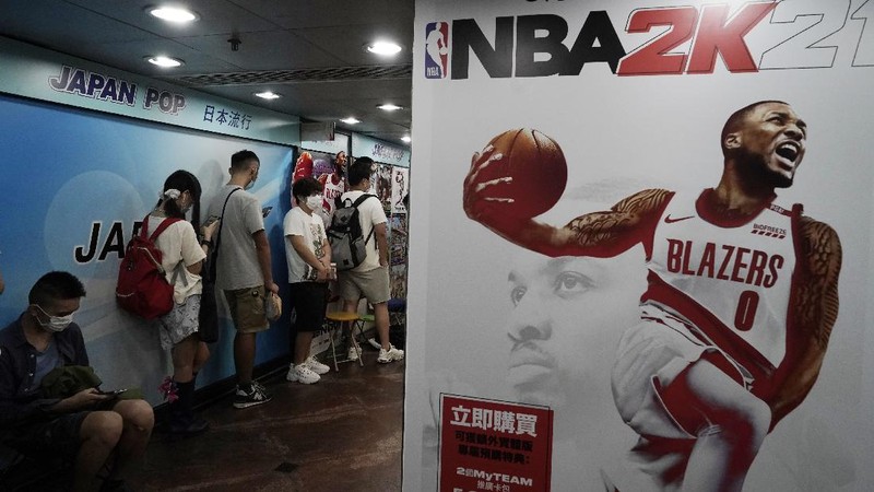 Gaming enthusiasts queue up for the pre-order sales of the newly unveiled Japanese brand video game console, Sony's PlayStation 5 (PS5), outside a retailer in Hong Kong, Friday, Sept. 18, 2020. Pre-orders of PlayStation 5 started on Sept. 17 and will be filled on Nov. 19. (AP Photo/Kin Cheung)