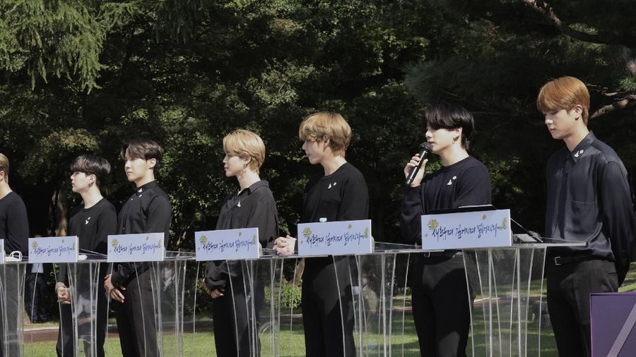 South Korean President Moon Jae-in, third from left, receives a gift from members of South Korean K-Pop group BTS during a ceremony marking the National Youth Day at the presidential Blue House in Seoul, South Korea, Saturday, Sept. 19, 2020. (Lee Jin-wook/Yonhap via AP)