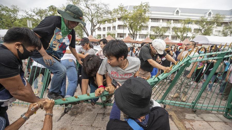 Pro-democracy demonstrators enter the Sanam Luang field, popular location for political protests, in Bangkok, Thailand, Saturday, Sept. 19, 2020. Protesters gathered Saturday in Bangkok for what was expected to be the biggest rally yet in an ongoing campaign calling for a new election and democratic reforms. (AP Photo/Gemunu Amarasinghe)