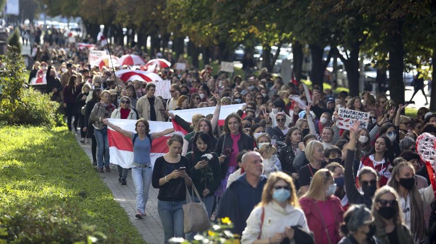 Women with old Belarusian national flags march during an opposition rally to protest the official presidential election results in Minsk, Belarus, Saturday, Sept. 19, 2020. Daily protests calling for the authoritarian president's resignation are now in their second month and opposition determination appears strong despite the detention of protest leaders. (AP Photo/TUT.by)
