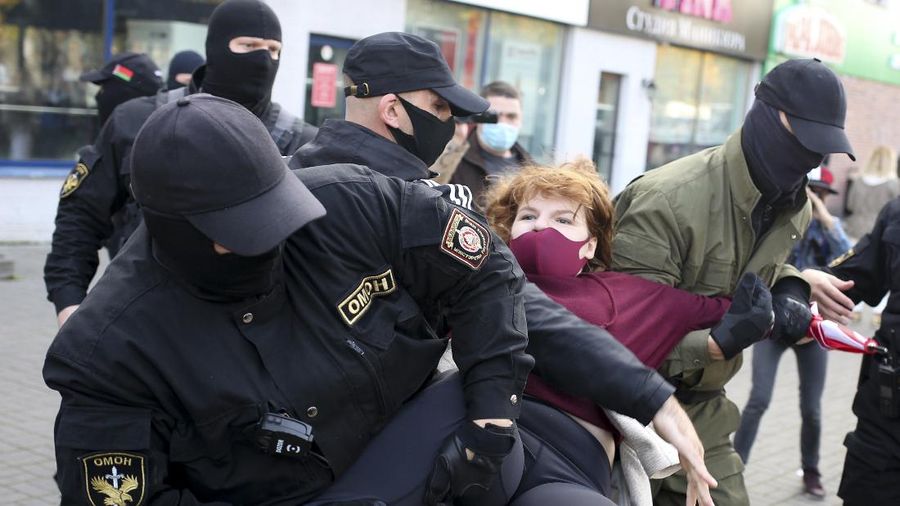 Police officers detain a woman during an opposition rally to protest the official presidential election results in Minsk, Belarus, Saturday, Sept. 19, 2020. Daily protests calling for the authoritarian president's resignation are now in their second month and opposition determination appears strong despite the detention of protest leaders. (AP Photo/TUT.by)