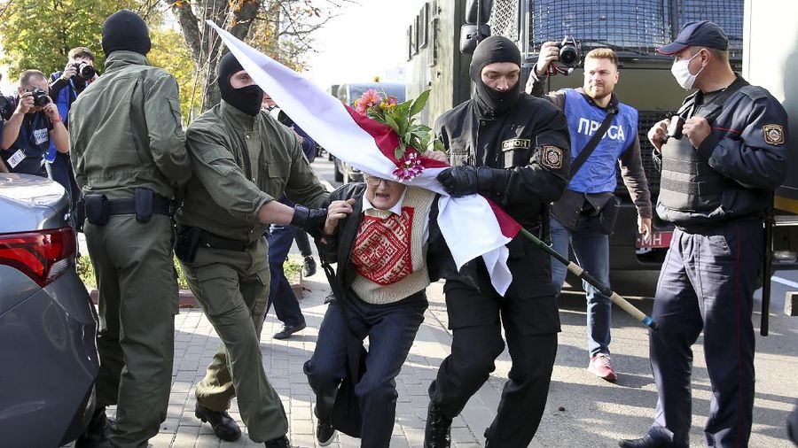 Women with old Belarusian national flags march during an opposition rally to protest the official presidential election results in Minsk, Belarus, Saturday, Sept. 19, 2020. Daily protests calling for the authoritarian president's resignation are now in their second month and opposition determination appears strong despite the detention of protest leaders. (AP Photo/TUT.by)