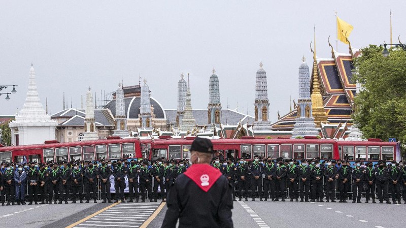 Pro-democracy protesters gesture as they listens to students leaders speech during a protest in Bangkok, Thailand, Sunday, Sept. 20, 2020. The mass student-led rally that began Saturday is the largest in a series of protests this year, with thousands camping overnight near the royal palace, demanding for new elections and reform of the monarchy. (AP Photo/Wason Wanichakorn)