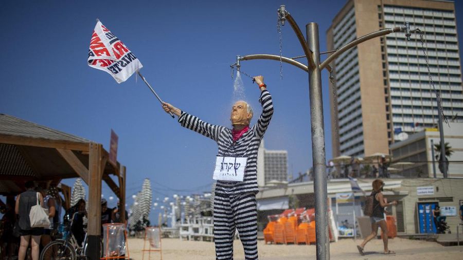 Acrobats perform as they wear face masks during a protest against government's decision to close beaches during the three-week nationwide lockdown due to the coronavirus pandemic, in Tel Aviv, Israel, Saturday, Sept 19, 2020. Israel went back into a full lockdown on Friday to try to contain a coronavirus outbreak that has steadily worsened for months as its government has been plagued by indecision and infighting. (AP Photo/Oded Balilty)